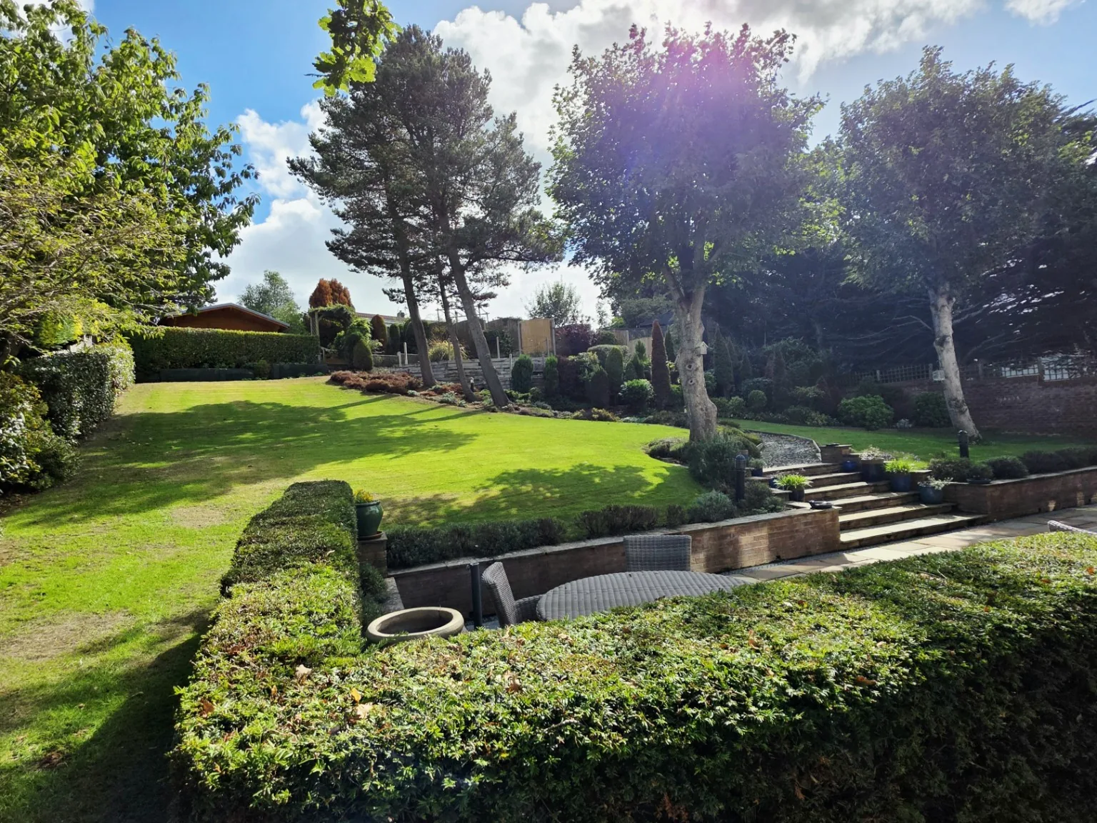 Finished garden with neatly maintained hedges and lawn